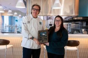 Photo of Chef and woman holding a plaque