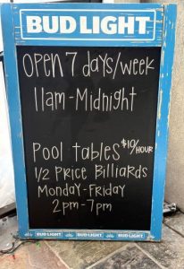 image of chalk sign with business hours